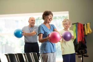 Senior adults exercise with yoga balls