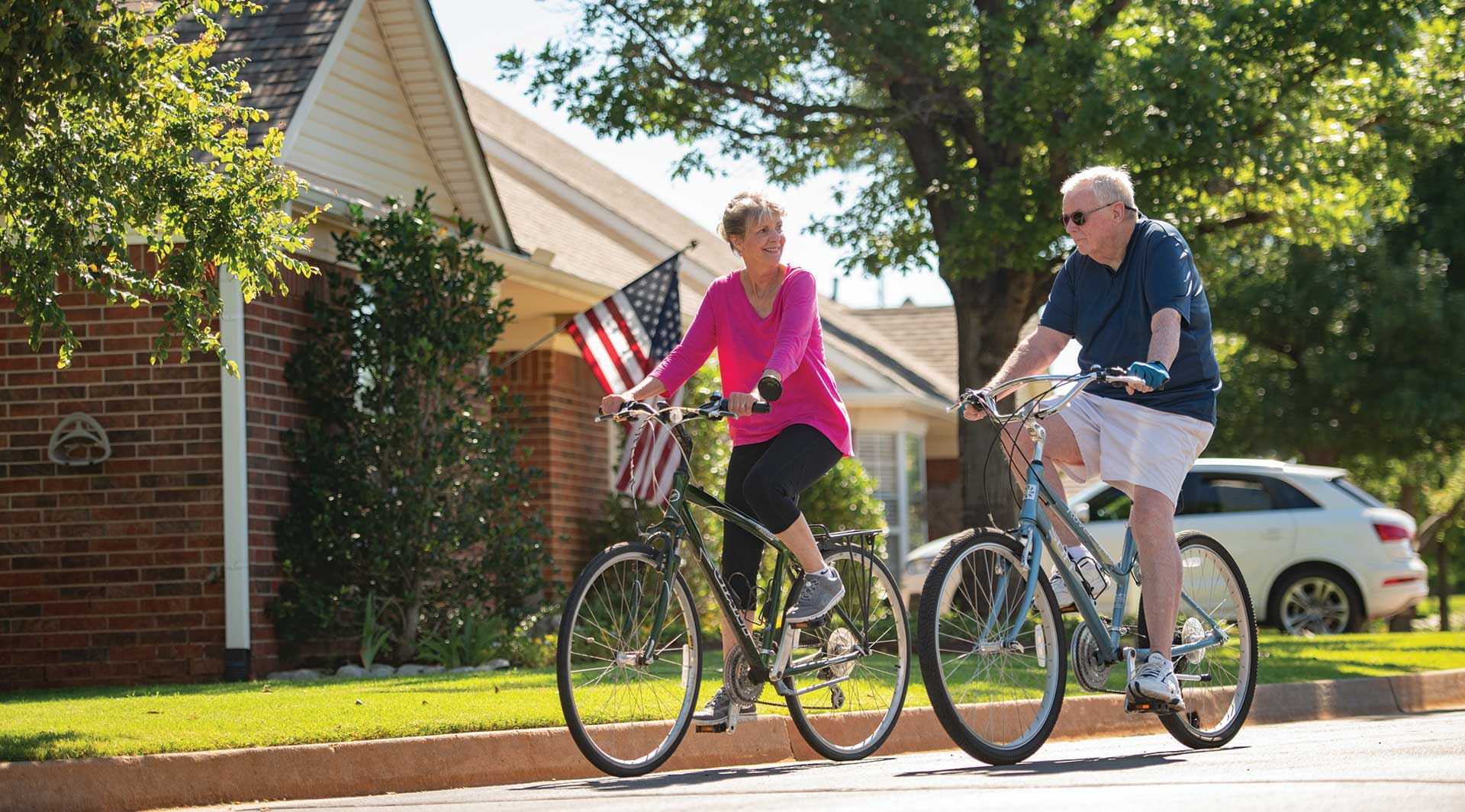 couple riding bikes down the street