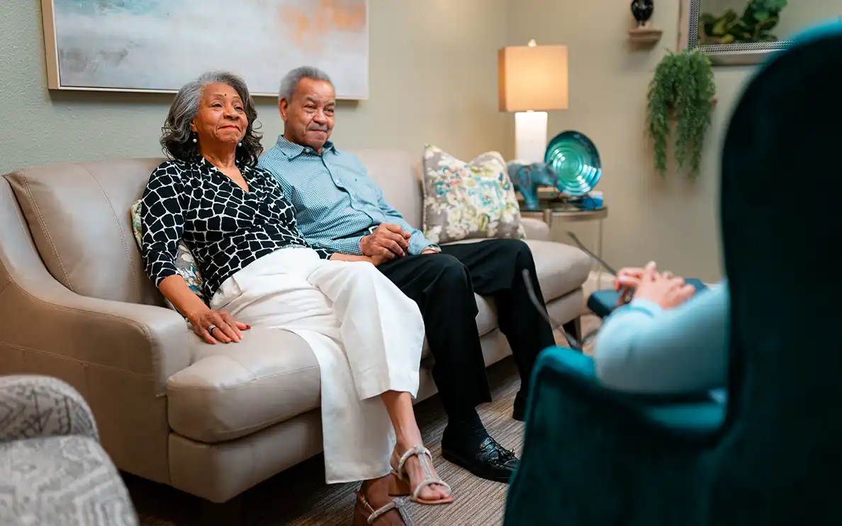 Couple sitting on a couch chatting