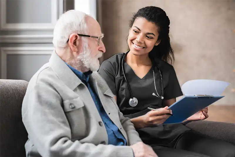 Nurse assisting a senior man