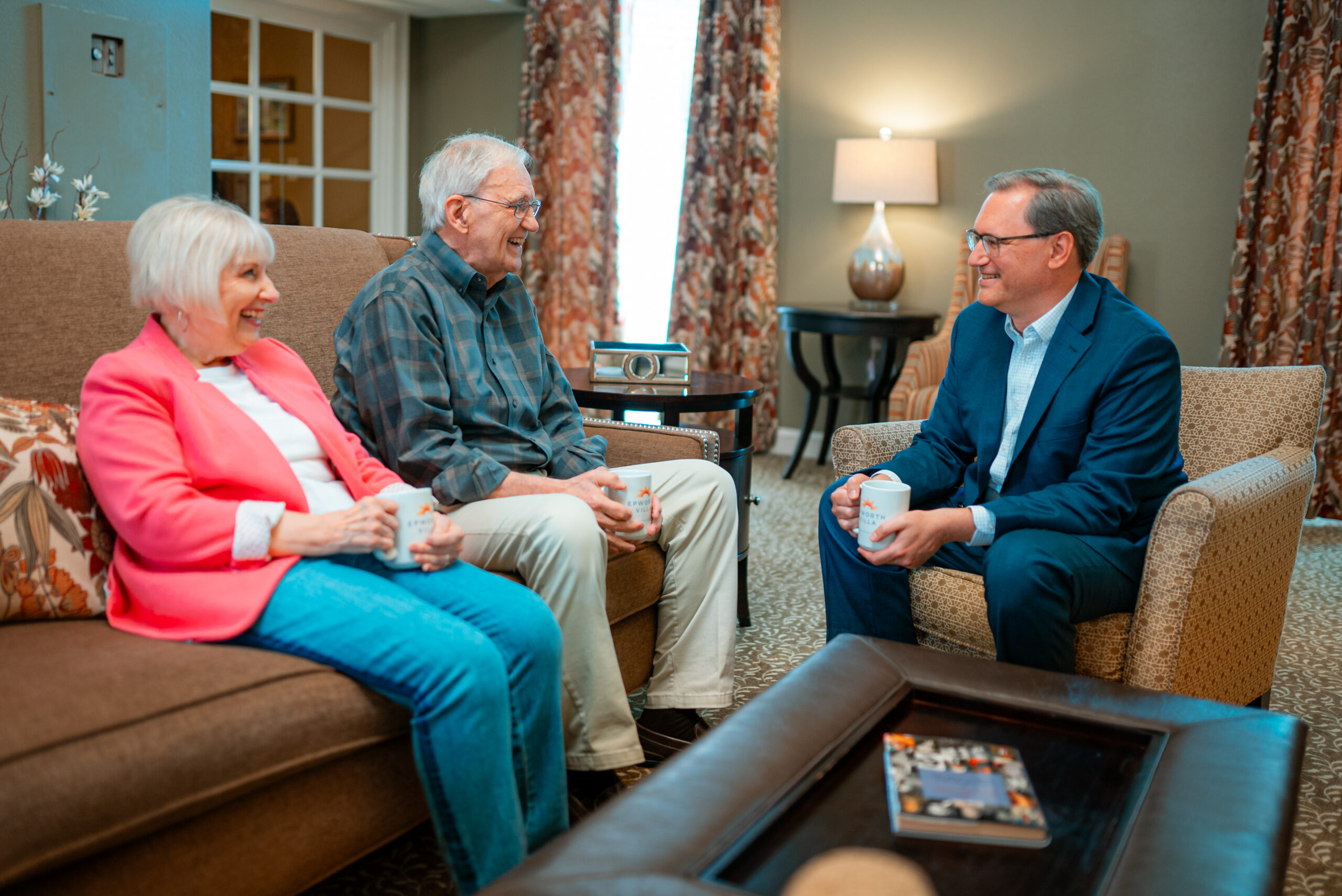 Senior couple meets with a director at an independent living community.