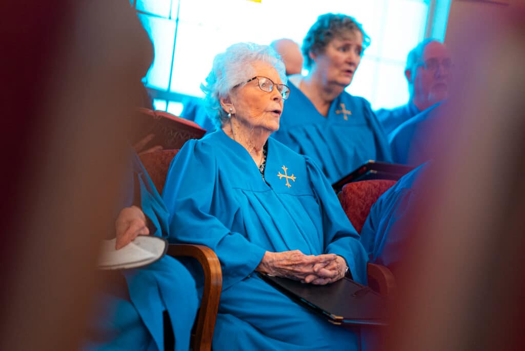 A senior attending a chapel service at Epworth Villa