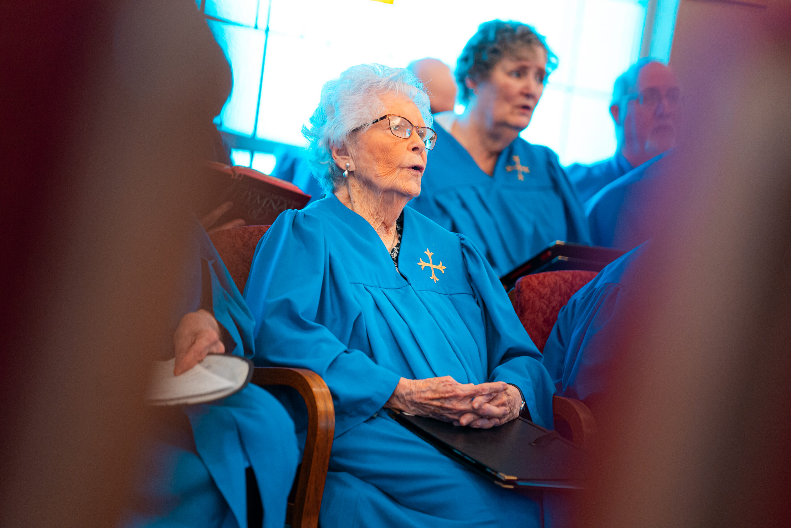 A senior attending a chapel service at Epworth Villa