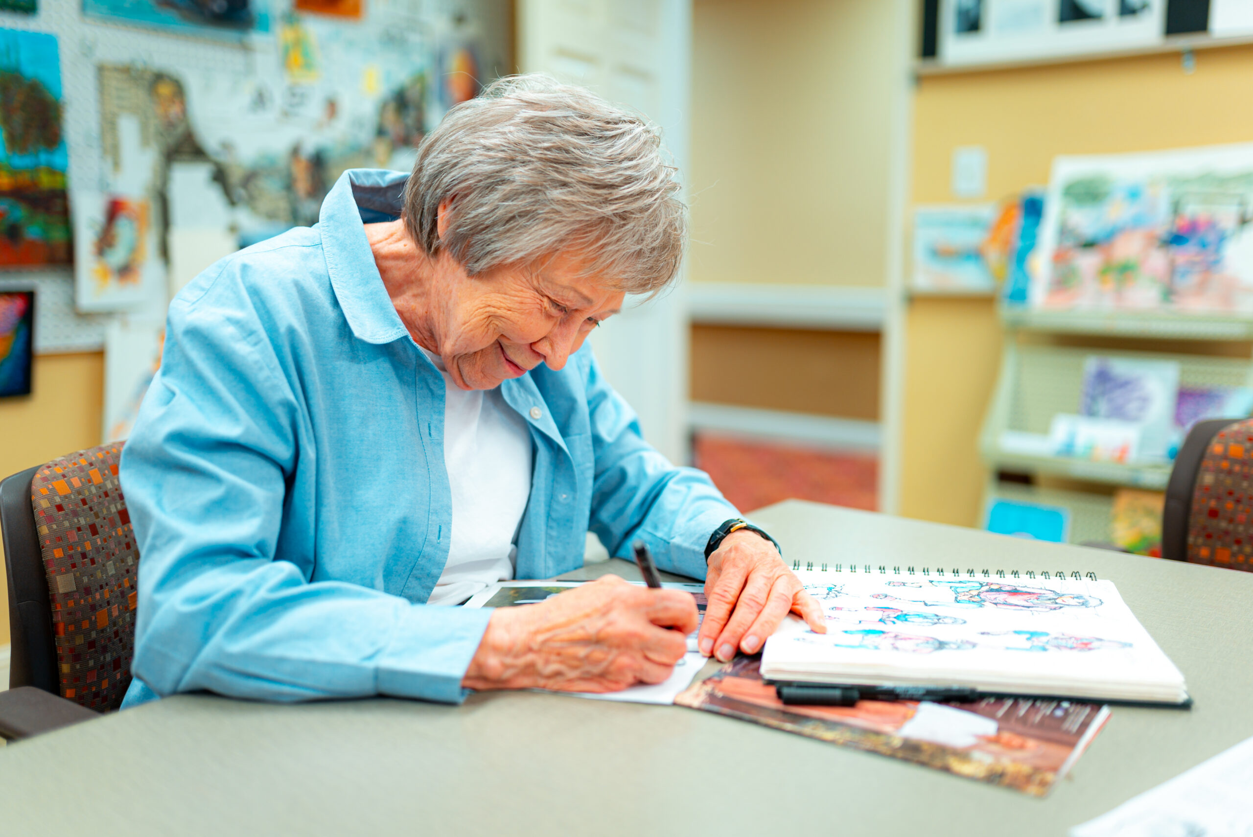 A senior resident learning painting at Epworth Villa’s workshops.
