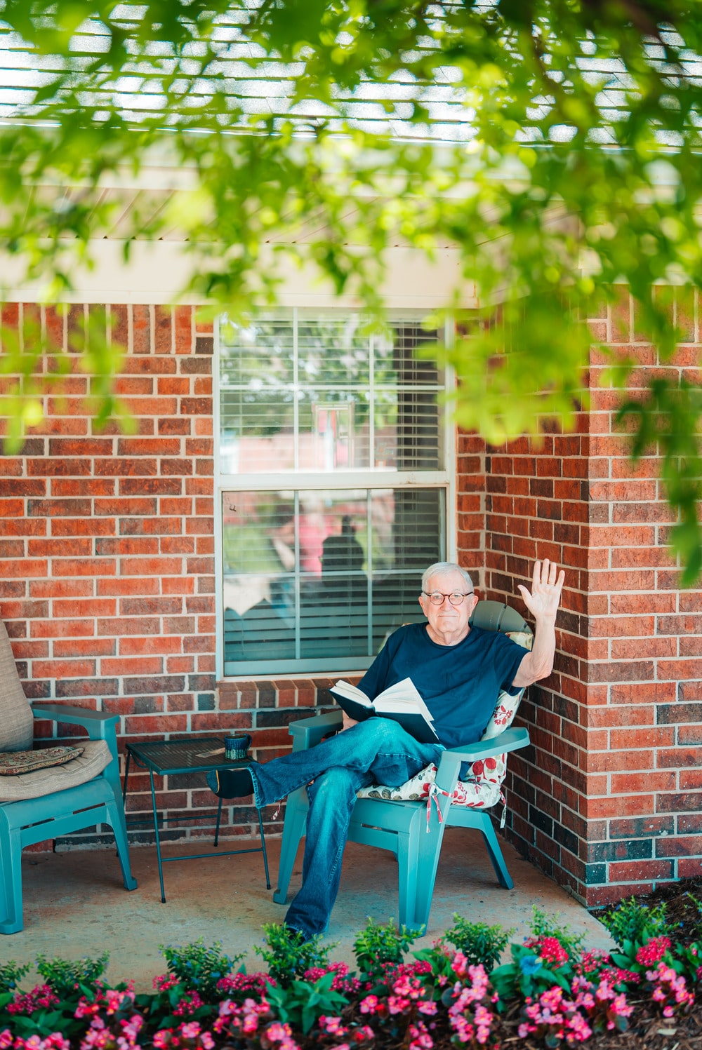 A senior sitting outside his cottage in Epworth Villa